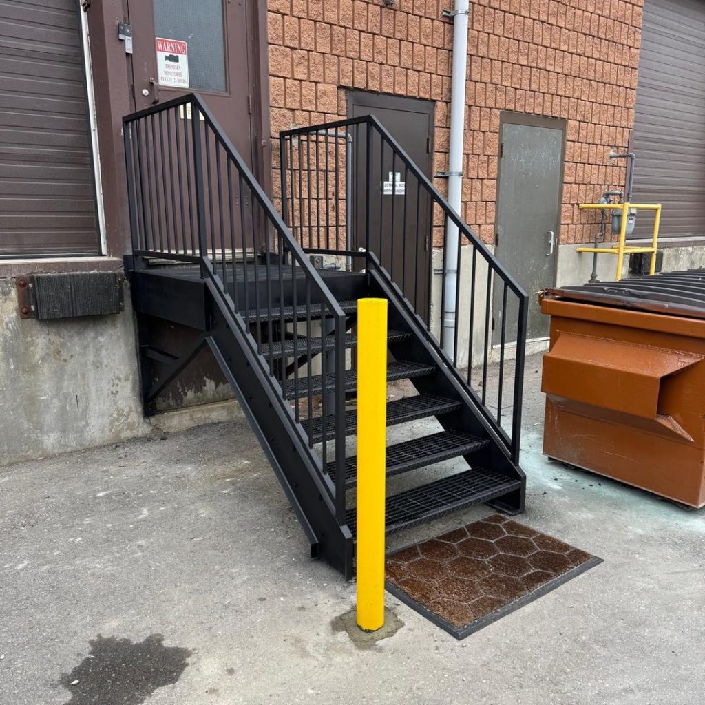 garage-steel-stairs-building-entry-steps-yellow-bollard